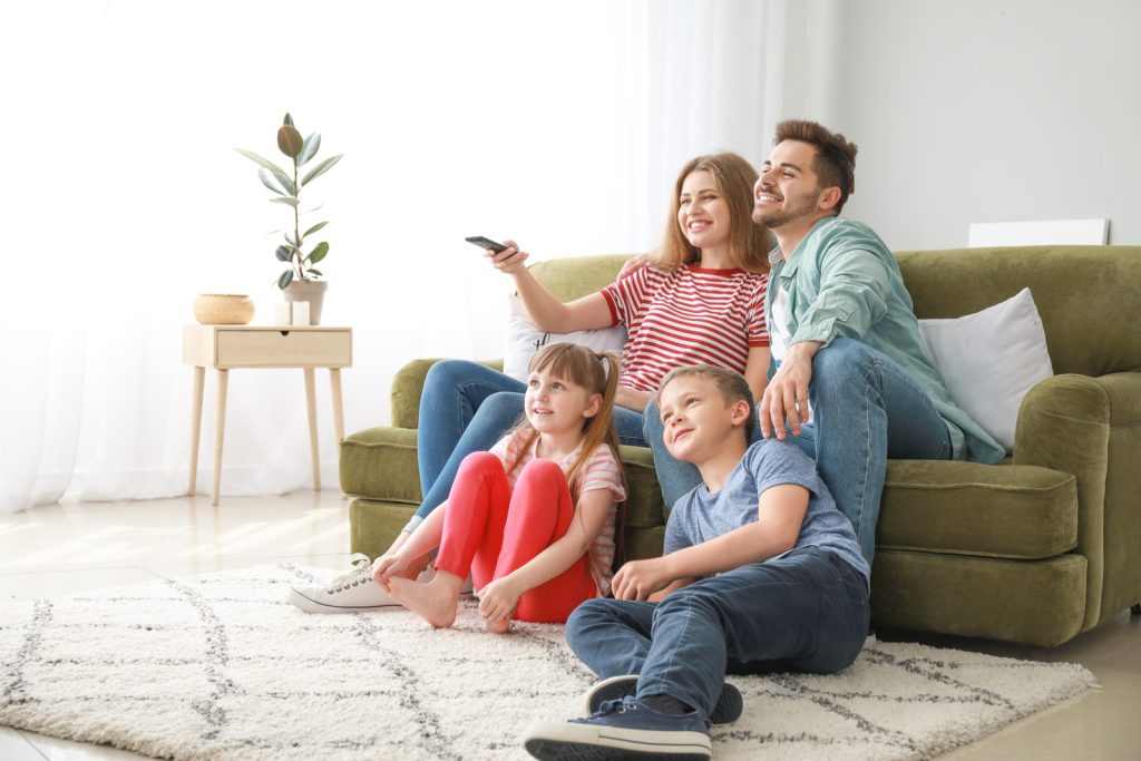 Happy family watching TV at home